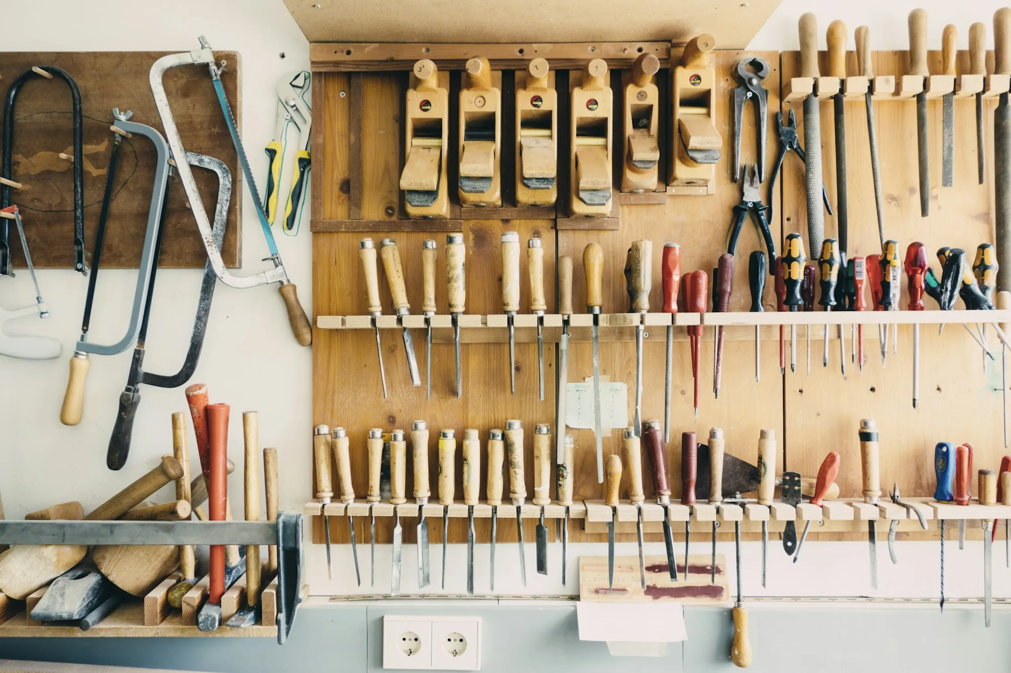 Hand tools hanging in an organized wall rack
