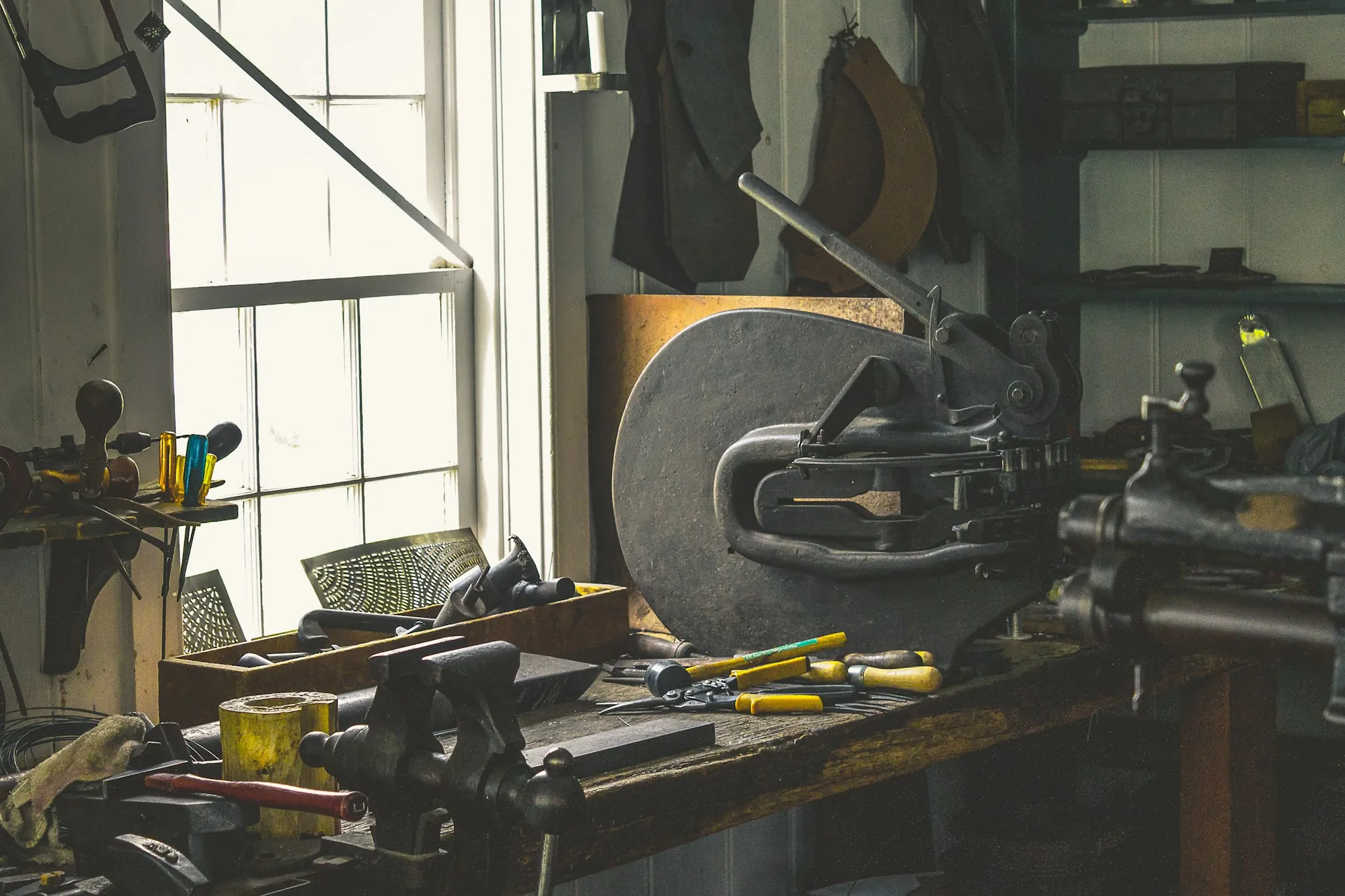 Workbench with a vise and tools in a home workshop